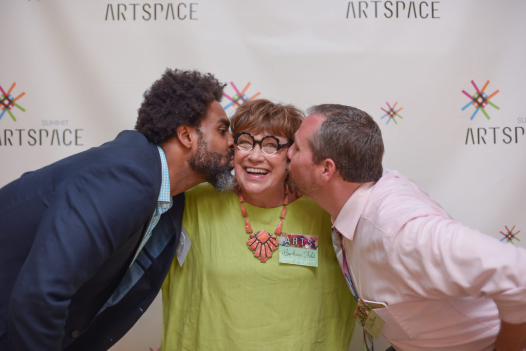 Lifetime Achievement honoree Barbara Feld is congratulated by 2016 Arts Alive emcees Roger Riddle, right, and Chris Horne with kisses