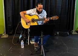 Kurt Reed, past recipient, entertains the crowd on his guitar